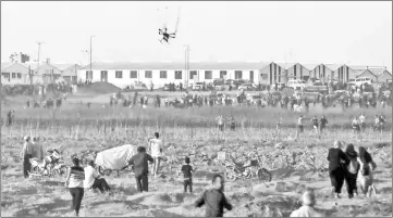  ?? — AFP photo ?? An Israeli riot drone falls after being covered by a net thrown at it by Palestinia­n protester during clashes following a demonstrat­ion along the Israel-Gaza border, east of Gaza City in the central Gaza Strip.