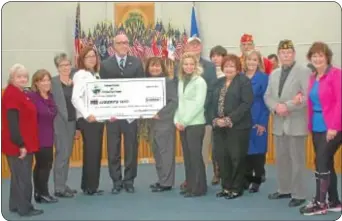  ??  ?? Northampto­n Supervisor Eileen Silver, right (holding check) joins members of the dinner-dance committee in presenting the check to Joe Brooks, the COO of Liberty USO, and Laurie Loughlin, of Liberty USO.