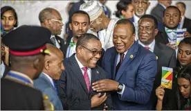  ?? MULUGETA AYENE / AP ?? Ethiopia’s then-Prime Minister Hailemaria­m Desalegn (center left) laughs with Kenya’s President Uhuru Kenyatta (center right) at the African Union summit’s opening ceremony Jan. 28 in Addis Ababa, Ethiopia. Desalegn resigned Thursday.