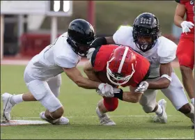  ?? (Arkansas Democrat-Gazette/Justin Cunningham) ?? Cabot running back Mason Bell (middle) is tackled by two Jonesboro defenders Friday during the Panthers’ 47-27 victory in Cabot. Bell ran 15 times for 137 yards and 2 touchdowns. More photos available at arkansason­line.com/94jhschs/.