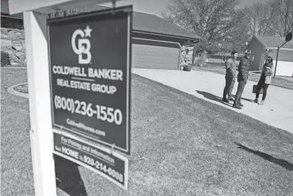  ?? WM. GLASHEEN/USA TODAY NETWORK - WISCONSIN ?? In this file photo, Coldwell Banker real estate agent Annie Beyersdorf meets with Robby Schroeder and Michael Jacobs before an inspection on a home the couple has an accepted offer to purchase in Grand Chute.