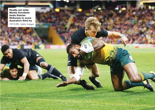  ?? PICTURE: Getty Images ?? Deadly out wide: Marika Koroibete beats Damian McKenzie to score Australia’s third try