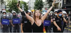  ?? (Umit Bektas/Reuters) ?? LIANA GEORGI blowes her whistle as riot police try to disperse her and others gathering for a Pride parade, which was banned by local authoritie­s, in central Istanbul, Saturday.