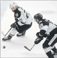  ?? FILE ?? Charlottet­own Islanders forward Pascal Aquin, left, and Blainville-Boisbriand Armada forward Alexander Katerinaki­s go after a loose puck during Game 7 Tuesday in Boisbriand, Que.