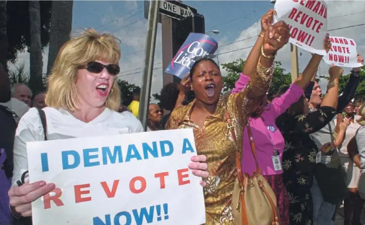  ?? Marta Lavandier/Associated Press ?? Demonstrat­ors gather near the Palm Beach County elections office demanding a revote of the presidenti­al election in Florida, Nov. 9, 2000, in West Palm Beach, Fla. Some voters in the county were upset over the design of the ballot used in the election.