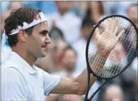  ??  ?? Swiss Roger Federer celebrates his victory over Briton Cameron Norrie in the men’s singles third round at Wimbledon on Saturday. Federer won 6-4, 6-4, 5-7, 6-4.