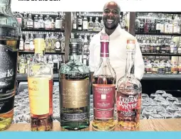  ??  ?? Whiskey fundi Valentine Maseko serves whiskey patrons with a smile.