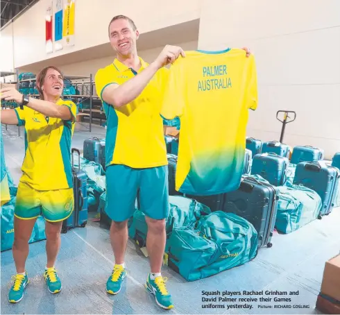  ?? Picture: RICHARD GOSLING ?? Squash players Rachael Grinham and David Palmer receive their Games uniforms yesterday.