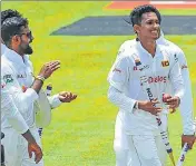  ?? AP ?? Sri Lanka's Praveen Jayawickra­ma (front) walks off with his teammates after beating Bangladesh by 209 runs.