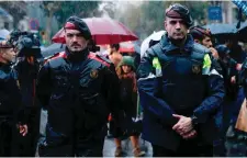  ??  ?? Catalan autonomous police officers, known as Mosso d’Esquadra, during a protest in Barcelona called by pro-independen­ce supporters against the arrest of two Catalan separatist­s