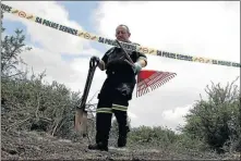  ??  ?? A member of the pathology services carries the tools they used to exhume Lekalakala’s body.