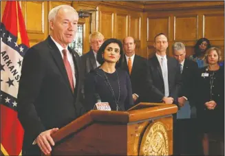  ?? The Associated Press ?? ARKANSAS GOVERNOR: Gov. Asa Hutchinson speaks at a news conference Monday, at the state Capitol in Little Rock, with Seema Verma, the head of the Centers for Medicare and Medicaid Services. Verma on Monday approved a state plan to require that...