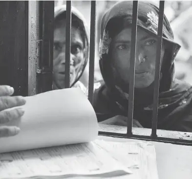  ?? ANUPAM NATH / THE ASSOCIATED PRESS ?? Women check if their names are included in Assam’s National Register of Citizens in Mayoung, India, on Monday. Residents unable to prove they or their families lived in the state before March 24, 1971 have been declared foreigners.