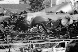  ?? RyAN reMIOrz / NATIONAL POST ?? Emergency crews are seen working in the wreckage
in devastated Lac-Mégantic, Que., in July.