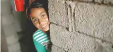  ?? — Reuters ?? Nine-year-old Iraqi girl Meriam looks out as she stands inside a house, east of Mosul, Iraq, on Saturday.