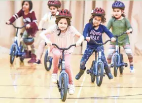  ?? SARA LIBERTE ?? Kindergart­ners in the All Kids Bike Program learn to ride bikes in their physical education classes.