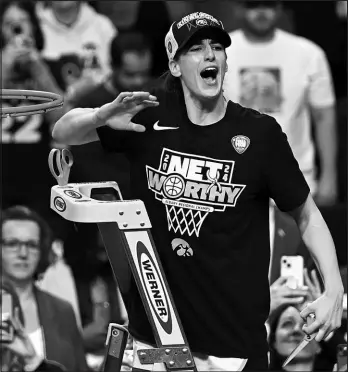  ?? HANS PENNINK / ASSOCIATED PRESS ?? Iowa guard Caitlin Clark reacts to the crowd before cutting a piece of the net Monday after Iowa defeated LSU in an Elite Eight round game during the NCAA Tournament in Albany, N.Y.