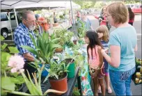  ?? RECORDER PHOTO BY CHIEKO HARA ?? Plant Pleasures James Breland, left, talks to customers Desiree Parker, 8, Temperance Stallions, 7, and Darlene Parker, right, Tuesday, June 5, at the Portervill­e Tuesday Farmers Market at Sierra View Medical Center.