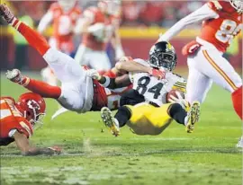  ?? Matthew Stockman Getty Images ?? A FLYING TAKEDOWN by Chiefs cornerback Marcus Peters sends Steelers wide receiver Antonio Brown (84) crashing to earth after one of his six catches.