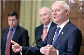  ?? (Staton Breidentha­l/ The Arkansas Democrat-Gazette via AP, File) ?? Gov. Asa Hutchinson, right, speaks March 23, 2020, in Little Rock.