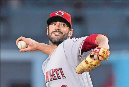  ?? MARK J. TERRILL/AP PHOTO ?? Cincinnati Reds starting pitcher Matt Harvey, above, throws during the first inning of the team’s game against the Los Angeles Dodgers on May 11 in Los Angeles. Harvey, below, as a Met, sits in the dugout during a 2016 game against the Washington...