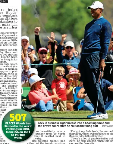  ?? GETTY IMAGES ?? Back in business: Tiger breaks into a beaming smile and the crowd roars after he rolls in that long putt
