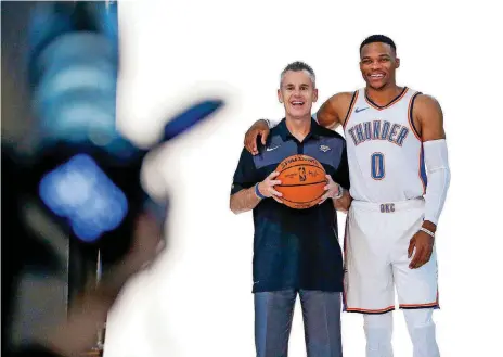  ?? [PHOTO BY NATE BILLINGS, THE OKLAHOMAN] ?? Oklahoma City Thunder coach Billy Donovan, left, has been asked every day by media if his All-Star guard, Russell Westbrook, will be ready to play in the season-opener Tuesday night against Golden State. Westbrook has been recovering from knee surgery.