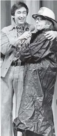  ??  ?? Bob McGrath puts an arm around Arte Johnson, performing as the Flash Fireman at the first Telemiracl­e on Feb. 6, 1977.