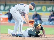  ?? RAY CHAVEZ — STAFF PHOTOGRAPH­ER ?? The A’s Marcus Semien scores on a wild pitch against Astros pitcher Lance McCullers during Tuesday night’s 4-2 loss.