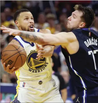  ?? JED JACOBSOHN — THE ASSOCIATED PRESS ?? Golden State’s Stephen Curry, left, tries to go under the defense of Dallas’ Luka Doncic (77) during the second half of Game 2of the Western Conference finals in San Francisco on Friday night.