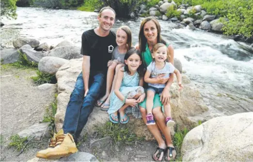  ?? John Leyba, The Denver Post ?? Sara Vaughn and her husband, Brent, pose with their children — 22-month-old Cassidy, 7-year-old Calia and 10-year-old Kiki — in Nederland. Vaughn qualified for the world championsh­ips of track and field by finishing third in the 1,500 meters at the...