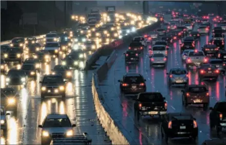  ?? THE ASSOCIATED PRESS ?? Early morning rush hour traffic crawls along the Hollywood Freeway toward downtown Los Angeles. One promise of ride-hailing companies was a drop in the number of cars in urban areas and an easing of clogged city streets. But a survey by an urban...