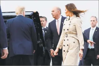  ?? Pablo Martinez Monsivais / Associated Press ?? President Donald Trump, left, listens to U.S. ambassador to the European Union, Gordon Sondland, center, on the tarmac after Trump’s arrival, with first lady Melania Trump, right, at Melsbroek Air Base on July 10, 2018 in Brussels, Belgium.