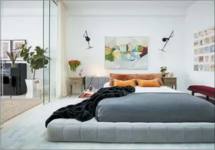  ?? RYAN DAUSCH — JDK INTERIORS VIA AP ?? This undated photo provided by Jenny Kirschner shows a bedroom designed by Kirschner. A striking work of art can make a room, as shown by this bedroom. It takes a careful touch, but homeowners can consider moving a piece of art they already own from...