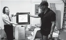  ?? TAIMY ALVAREZ/ STAFF PHOTOGRAPH­ER ?? Patrick Coulton, right, and his lawyer, Paul Petruzzi, show a certificat­e from the state Supreme Court to Peter Mayas found among court papers Coulton’s ex- attorney left behind.