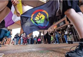  ?? DOUG ENGLE/OCALA STAR-BANNER ?? About 100 students gathered Thursday at Turlington Hall at the University of Florida in Gainesvill­e, Fla., part of a statewide walkout in protest of recent education-related efforts by Gov. Ron DeSantis, including his policies targeting LGBTQ people and people of color.