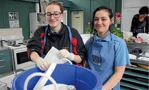  ?? JANE MATTHEWS/ STUFF ?? Ha¯ wera High School Students Maddison Hayes, 15, and Ivy Wall, 13, worked on the first stages of their blue cheese production.