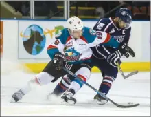  ?? CINDY ROGERS/www.nyasa.ca ?? Dillon Dube of the Kelowna Rockets and Tyler Sandhu of the Tri-City Americans battle for the puck in WHL action Saturday night at Prospera Place in Kelowna.The Rockets won 4-2.