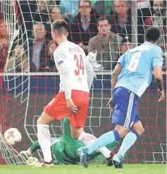  ?? — Reuters photo ?? Marseille’s Rolando (right) scores the first goal during the UEFA Europa League semi-final second leg match against FC Salzburg in Salzburg, Austria.