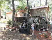  ?? LAURA BAIRD/ASSOCIATED PRESS ?? Evan (from left), Jasmine and Jessica Baird play outside of their family’s 440-square-foot cabin on wheels in Myrtle Beach, S.C.