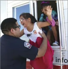  ??  ?? Art Yerena (left), chief of the IVC Fire Academy, "rescues" a "victim" at the Brawley Fire Department annual fire prevention open house on Saturday. WILLIAM ROLLER PHOTO