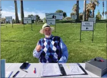  ?? COURTESY PHOTO ?? Tony Viola, president of Grandfathe­rs for Golf, sits at the check-in table at the organizati­on’s Feb. 25 Memorial Tournament at Soboba Springs Golf Course in San Jacinto. The signs behind him represent Grandfathe­rs for Golf volunteers who have died.