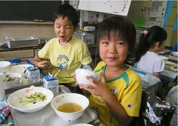  ??  ?? Nutritious meal: Schoolchil­dren enjoying their school lunches at the Nisikasai Elementary School in Tokyo. Unlike the cafeteria system operated in some Western countries, Japanese school lunches are usually served in the classroom.