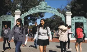  ?? Michael Short / The Chronicle 2014 ?? Students walk past Sather Gate into Sproul Plaza on the UC Berkeley campus. The UCs have been increasing the number of California residents admitted.