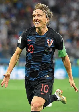  ??  ?? 10 out of 10: Luka Modric celebrates after scoring Croatia’s second with a stunning 25-yard curling finish