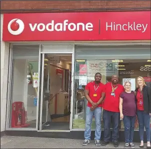  ??  ?? Members of staff outside the Vodafone shop in Hinckley