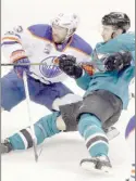  ?? The Associated Press ?? Edmonton Oilers centre David Desharnais, left, is defended by San Jose Sharks right wing Melker Karlsson during the third period in Game 4 of a first-round NHL hockey playoff series Tuesday in San Jose, Calif.