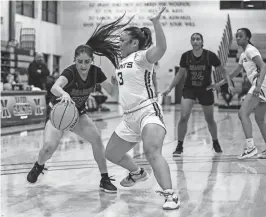  ?? ANDY ABEYTA/THE DESERT SUN ?? Shadow Hills’ Analiah Cardona (23) works toward the hoop while covered by Xavier Prep’s Tiffany Chang (3) during the second quarter Thursday’s game at Xavier College Preparator­y High School in Palm Desert.