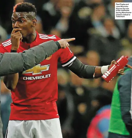  ??  ?? Paul Pogba and Jose Mourinho discuss the role of the midfielder during Manchester United’s defeat to Tottenham