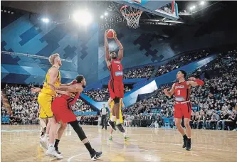  ?? RICHARD WAINWRIGHT THE ASSOCIATED PRESS ?? Melvin Ejim grabs a rebound in an exhibition basketball game against Australia in Perth. Canada lost, 81-73.